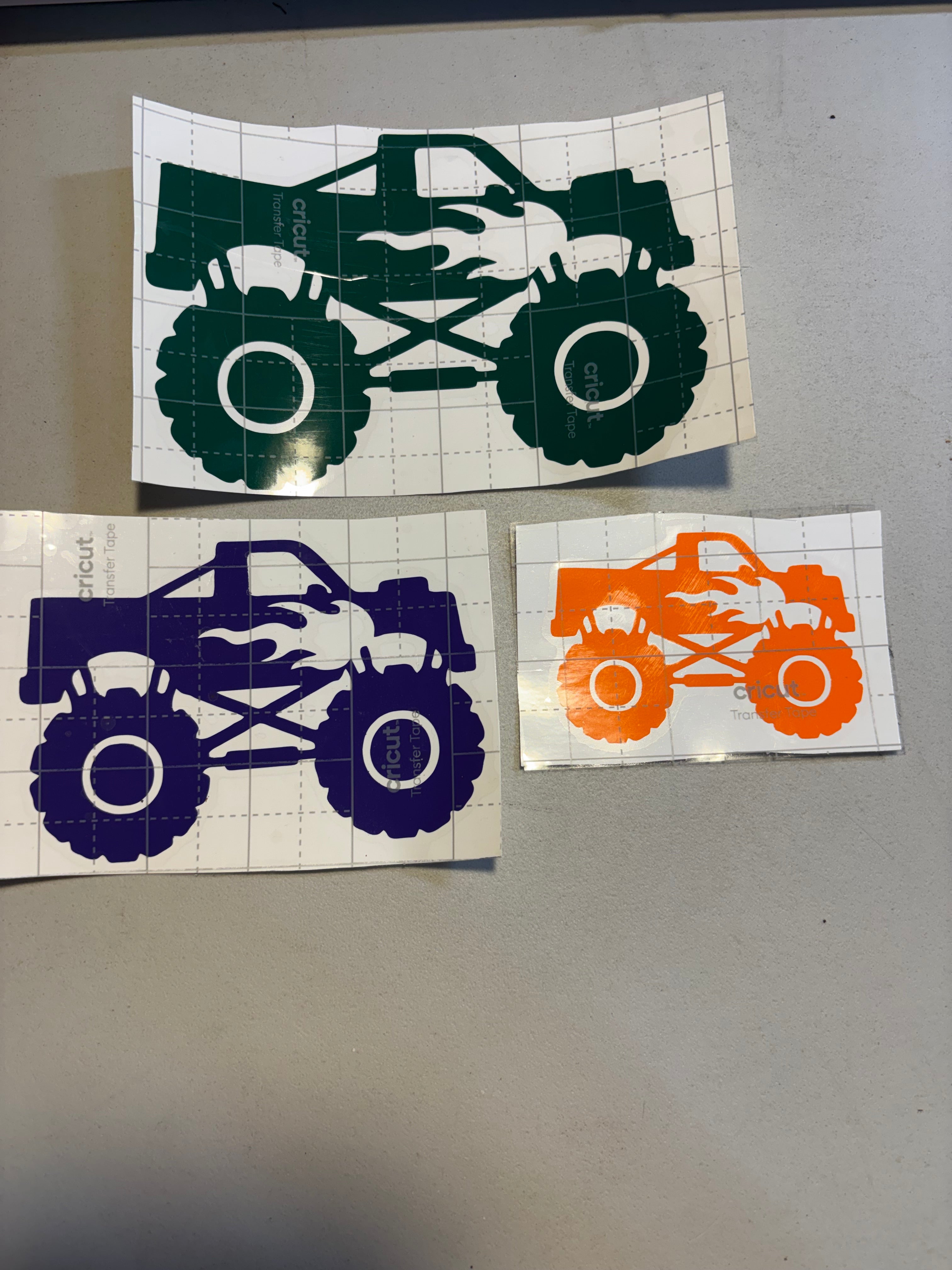 Monster truck with flame decal shown in green, purple, and orange